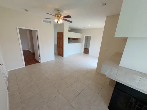 a view of a kitchen with furniture and a ceiling fan