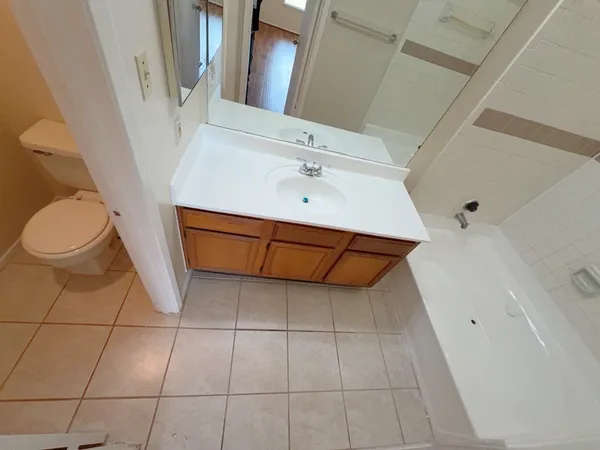 a bathroom with a sink a toilet and a mirror
