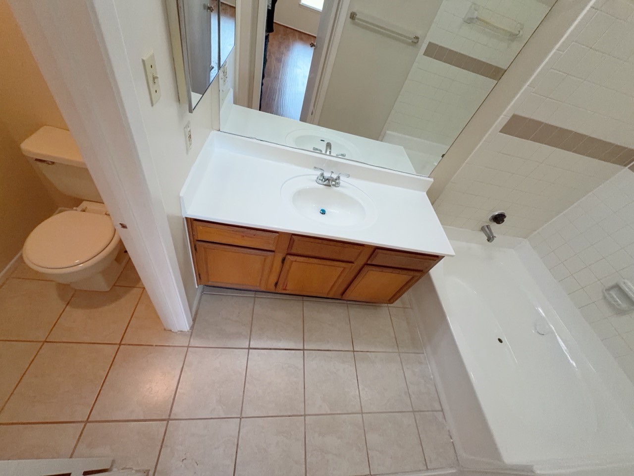 7900 Bissonnet Street, Unit C14 Houston, TX 77074 - Photo 9 of 14 a bathroom with a sink a toilet and a mirror