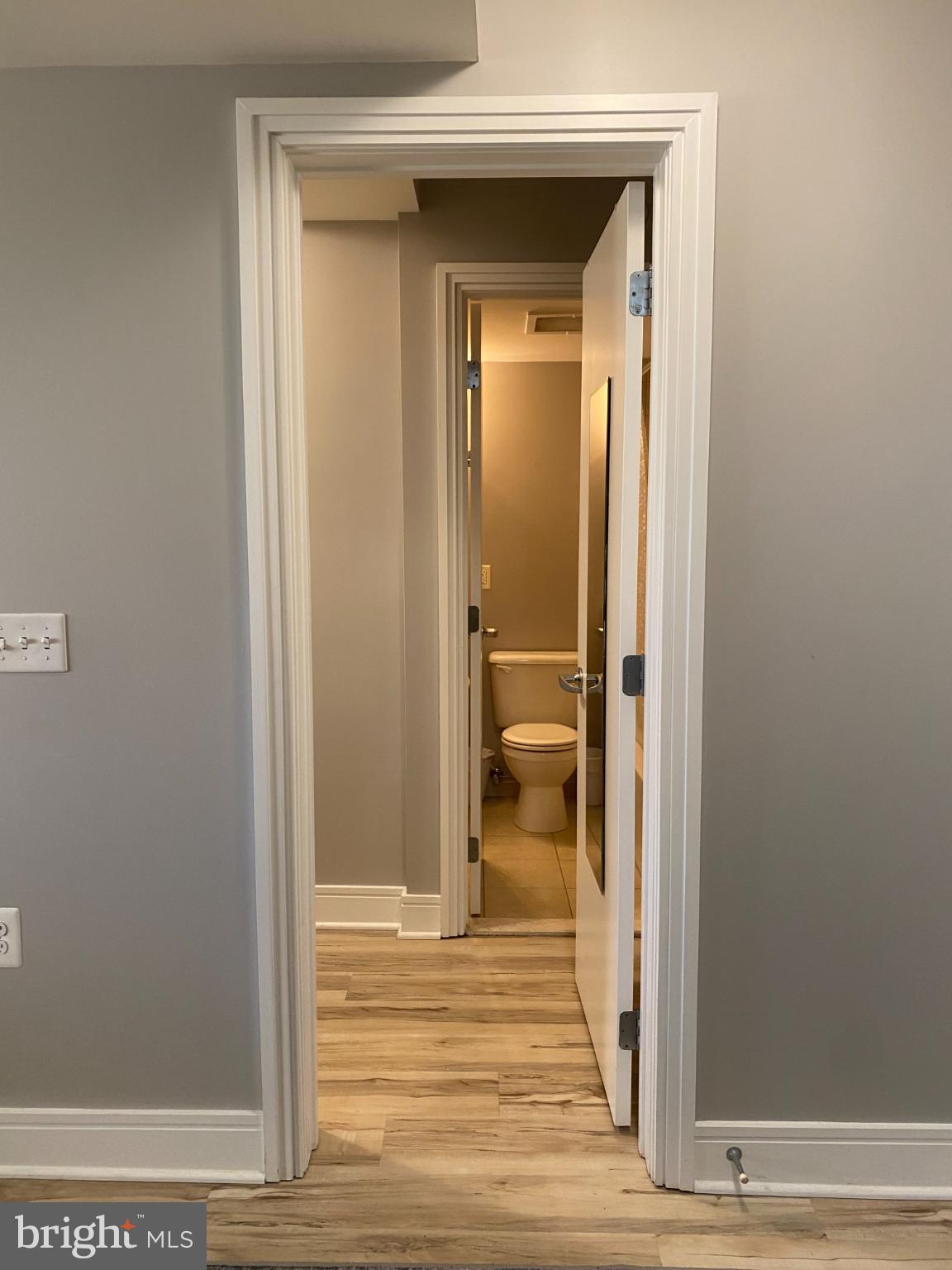 800 4th Street Southwest, Unit 610 Washington, DC 20024 - Photo 11 of 11 Inviting hallway leading to a serene bathroom.