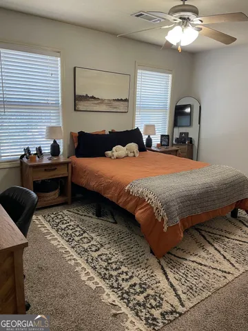 a bedroom with double bed and a window