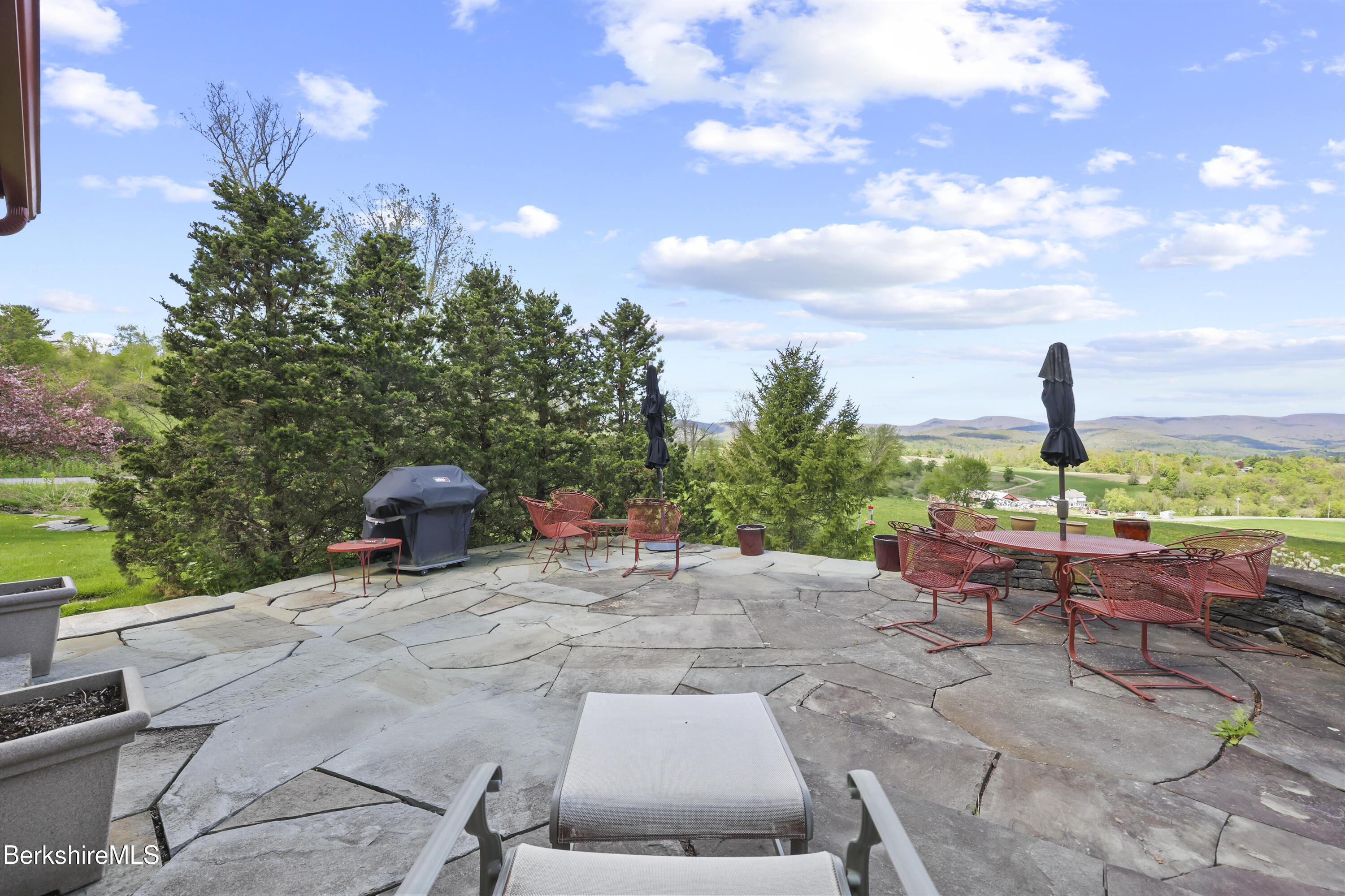 821 Pattison Road North Adams, MA 01247 - Photo 49 of 68 a view of a patio with a table and chairs under an umbrella