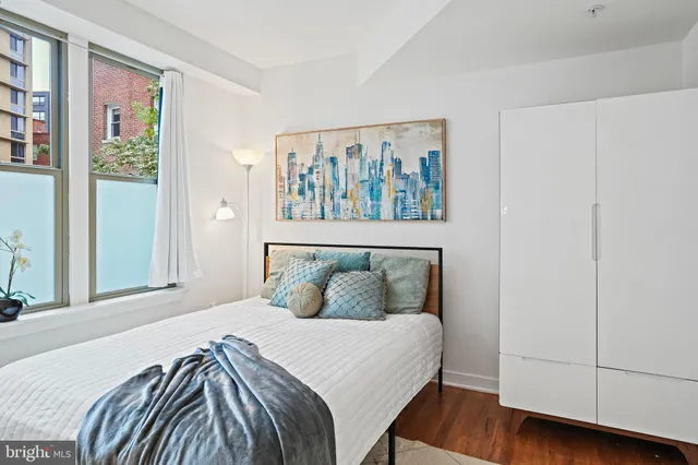 a bedroom with a bed and a window