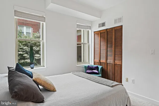 a bedroom with a bed and glass window