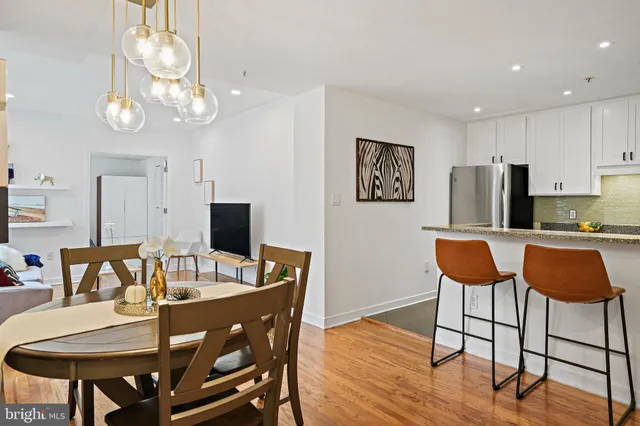 a view of a dining room with furniture and wooden floor