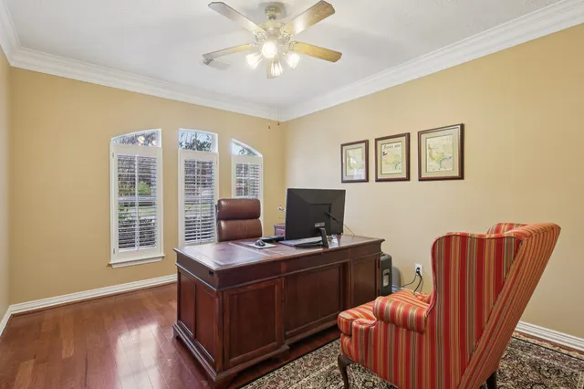 a view of a workspace with furniture and a window