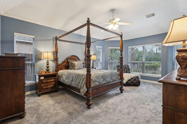 a bedroom with a bed and a lamp with window