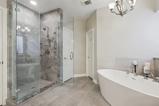 a bathroom with a bathtub and shower