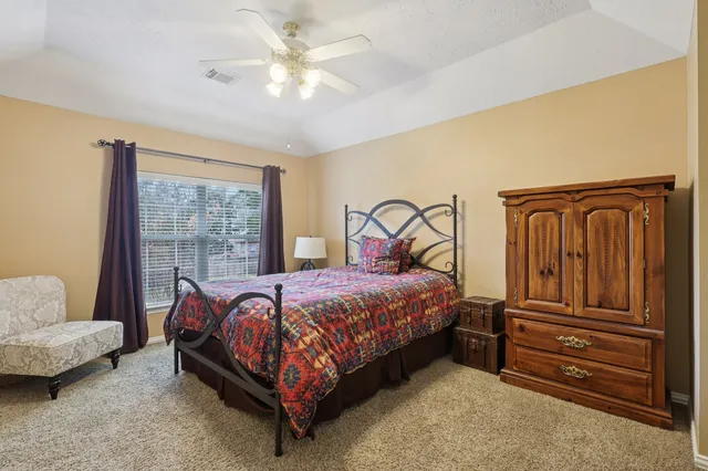 a bedroom with a bed and a couch