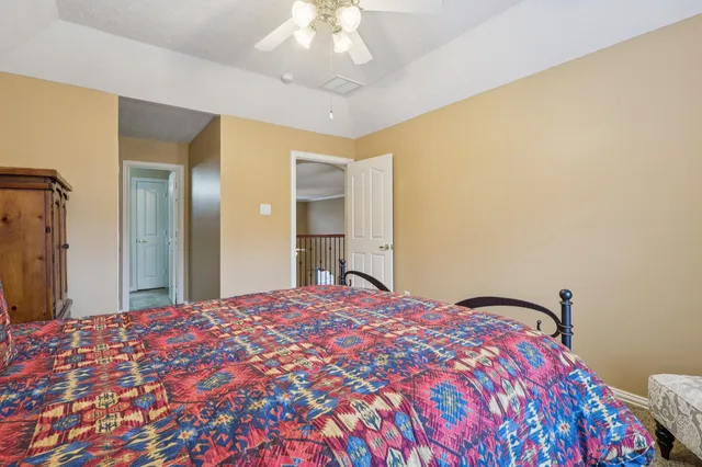 a bedroom with a bed and a mirror