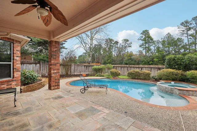 a view of swimming pool with a patio and a yard