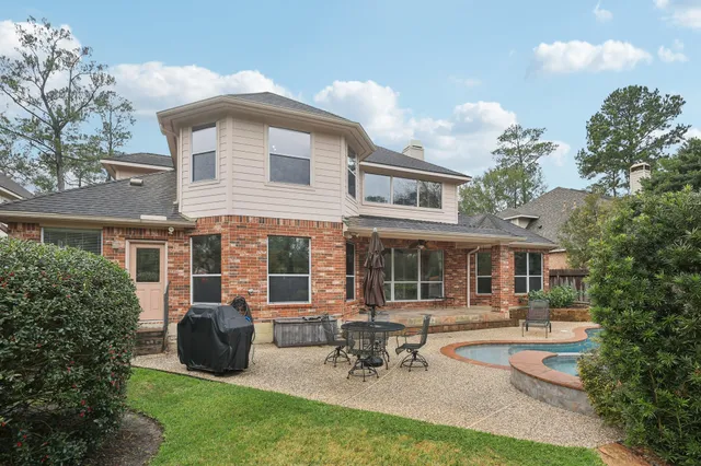 a view of a house with a yard and sitting area