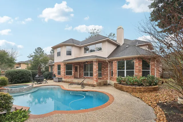 a view of a house with pool table and chairs