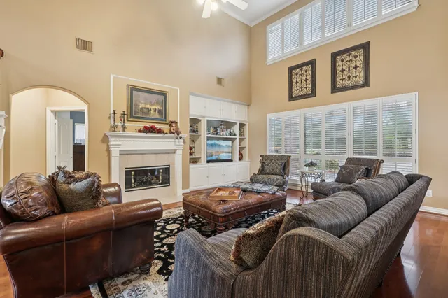a living room with furniture fireplace and a large window