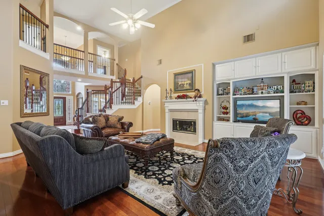 a living room with furniture a rug and a wall painting