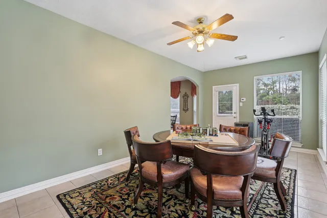 a view of a dining room with furniture and a chandelier fan