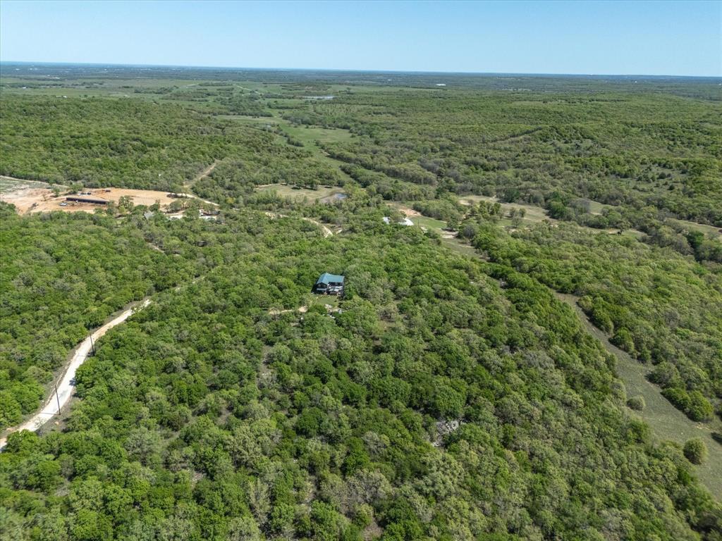 900 Old Spring Road Nocona, TX 76255 - Photo 13 of 27 an aerial view of residential houses with outdoor space and trees all around