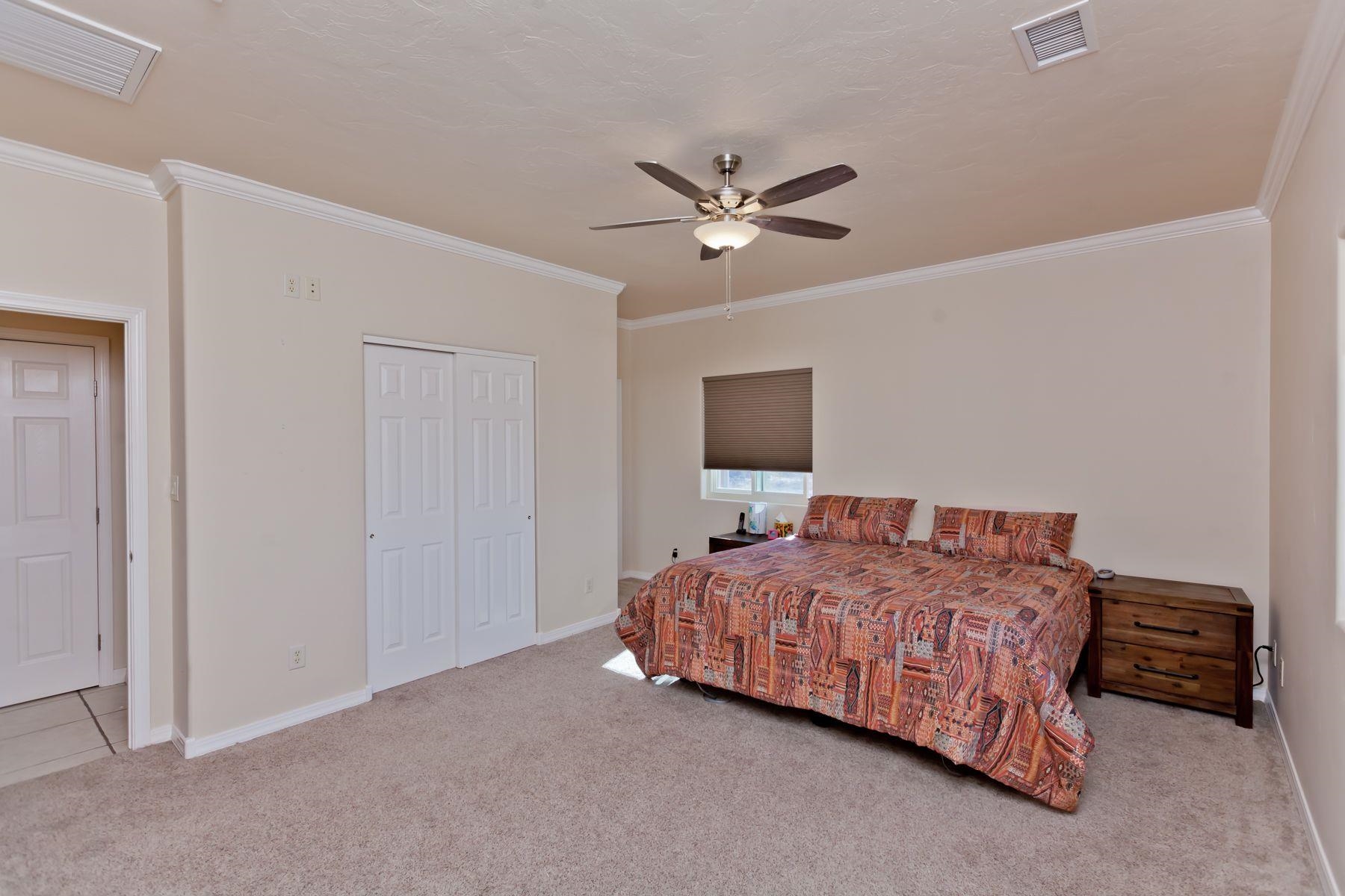 1353 19 Road Fruita, CO 81521 - Photo 28 of 42 a living room with a bed furniture and a flat screen tv