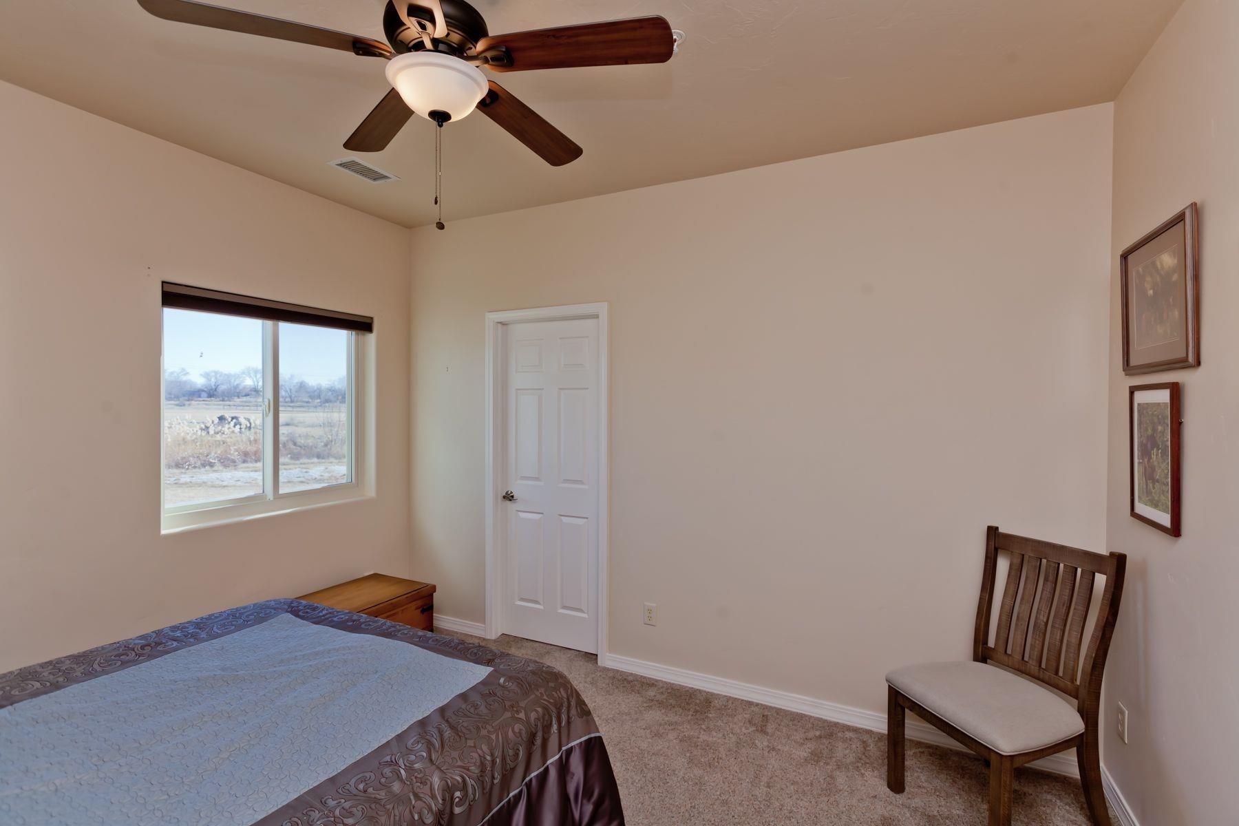 1353 19 Road Fruita, CO 81521 - Photo 38 of 42 a bedroom with a bed and a chair