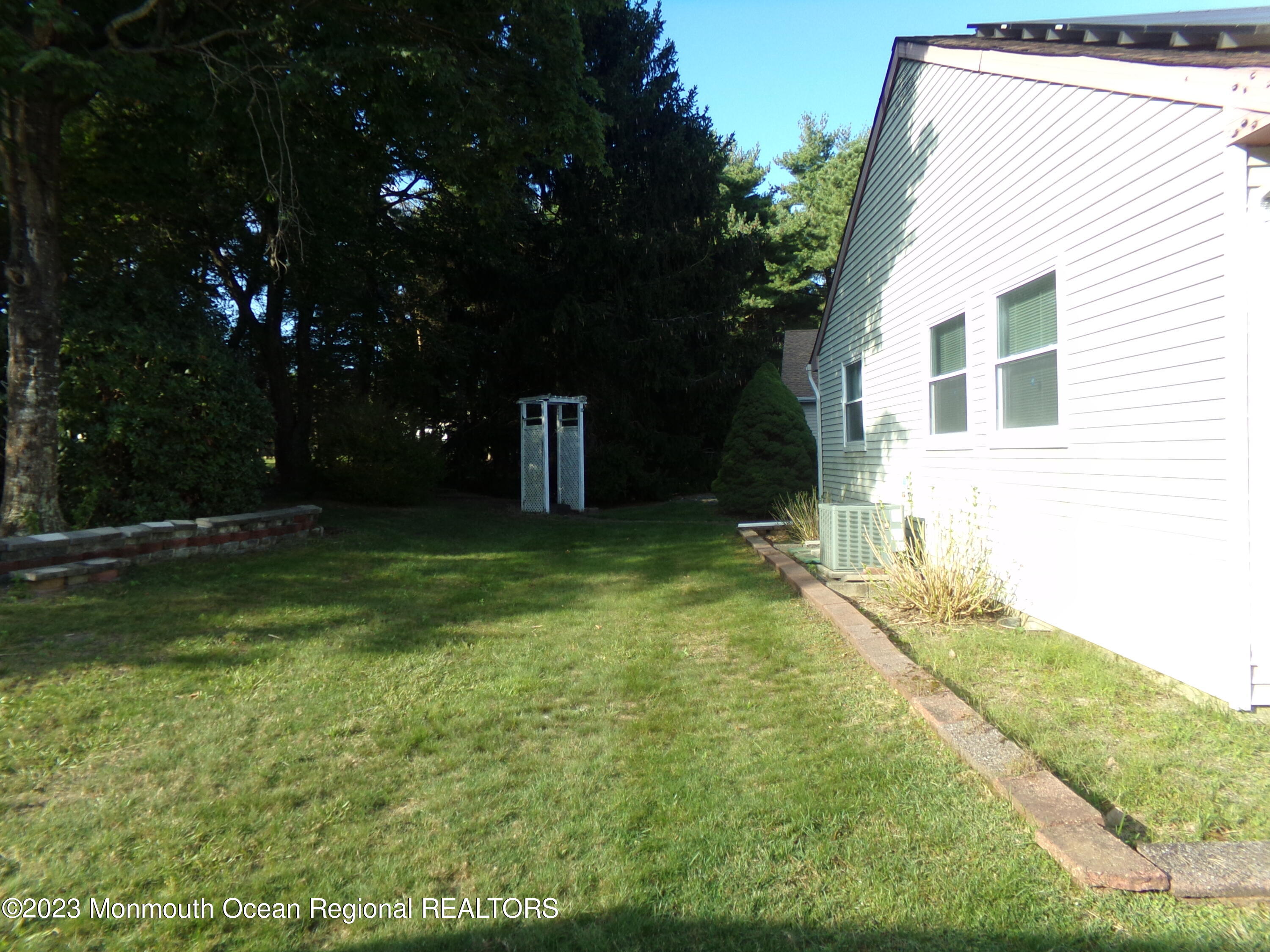 11 Ardmore Street, Unit 61 Whiting, NJ 08759 - Photo 34 of 34 a backyard of a house with lots of green space and garden