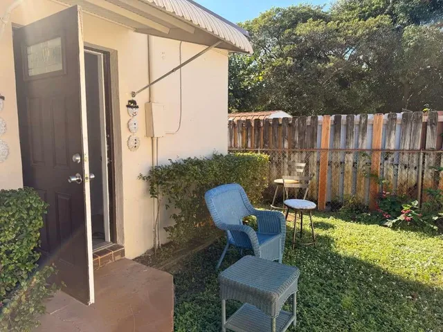 a view of a chairs in backyard of the house