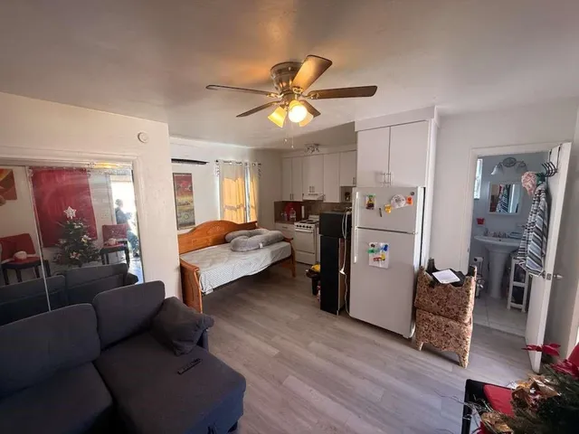 a living room with furniture and a chandelier