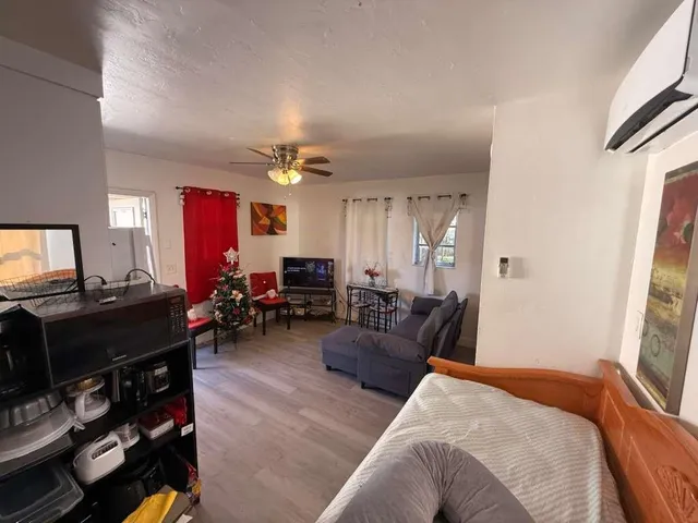 a bedroom with furniture and a mirror