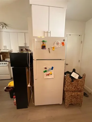 a utility room with refrigerator and washer