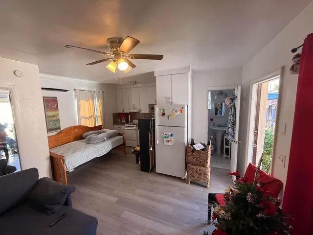 a living room with furniture chandelier and a window