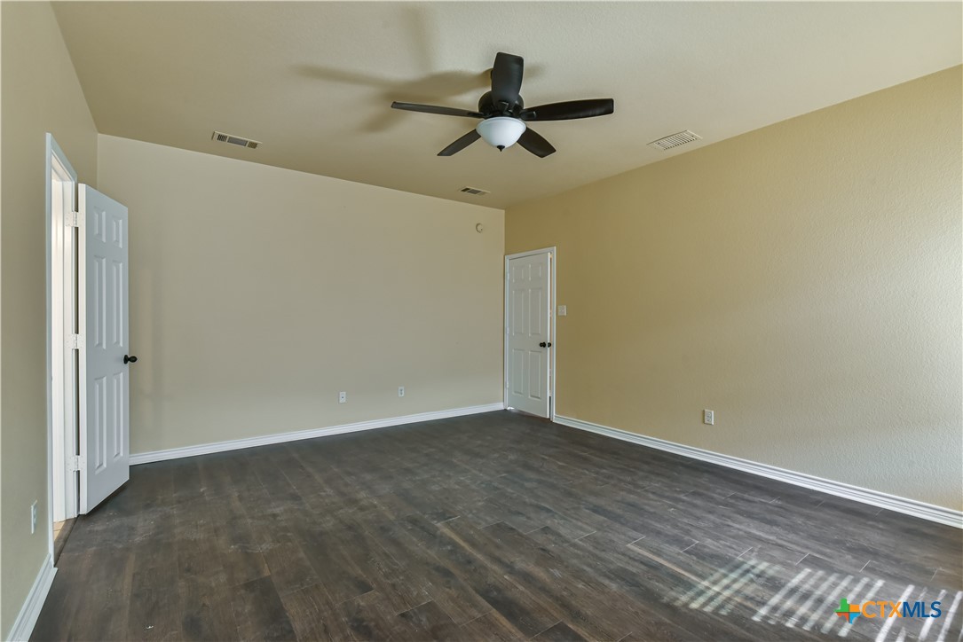 6905 Deorsam Loop Killeen, TX 76542 - Photo 11 of 21 a view of empty room with wooden floor