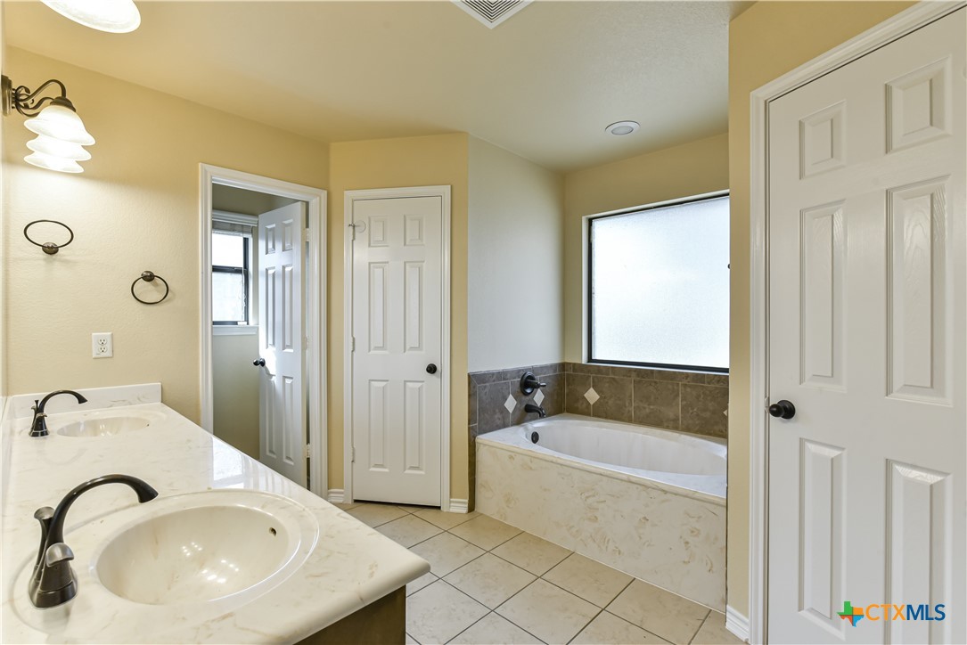 6905 Deorsam Loop Killeen, TX 76542 - Photo 18 of 21 a bathroom with a sink and a bathtub