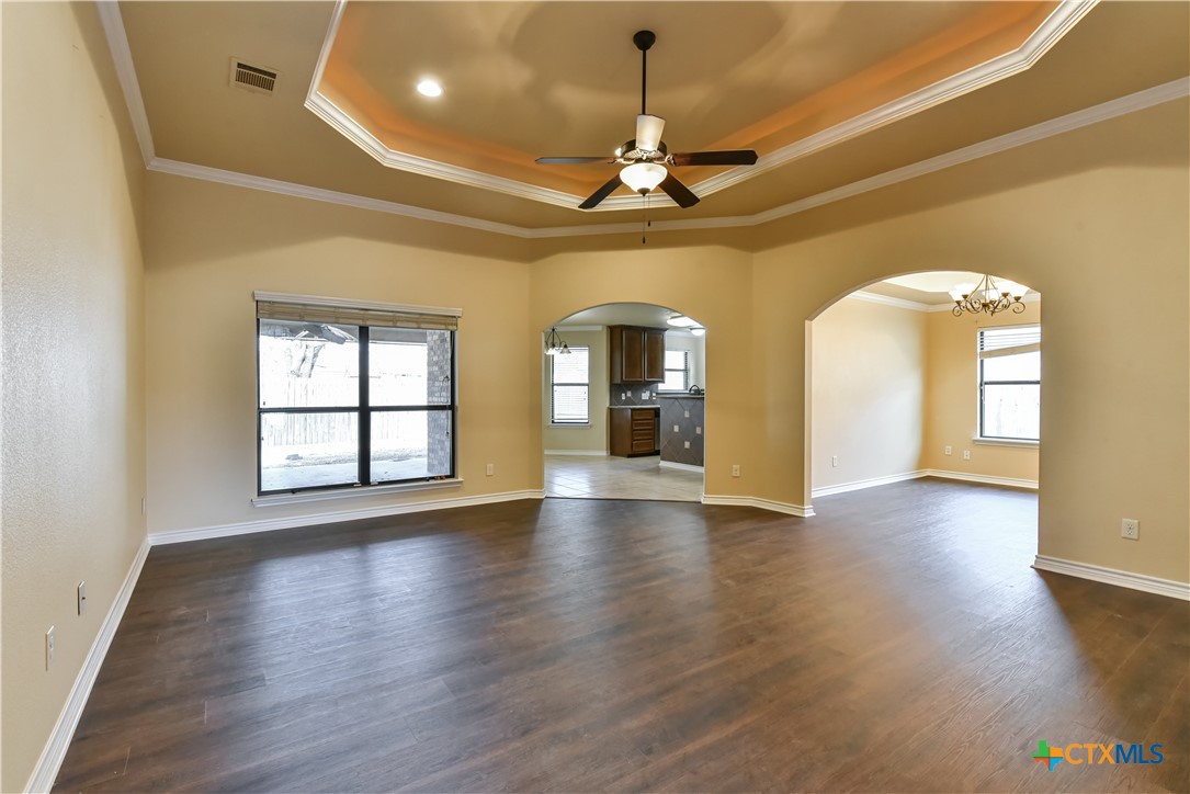 6905 Deorsam Loop Killeen, TX 76542 - Photo 2 of 21 a view of an empty room with wooden floor and a window