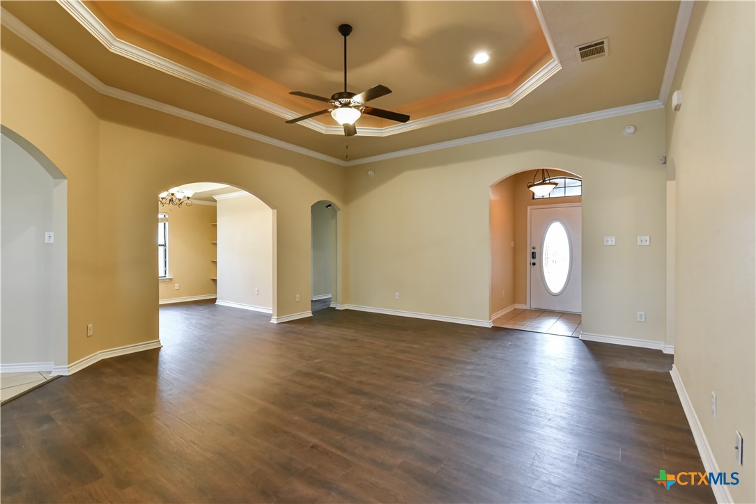 6905 Deorsam Loop Killeen, TX 76542 - Photo 6 of 21 a view of an empty room with wooden floor and a ceiling fan