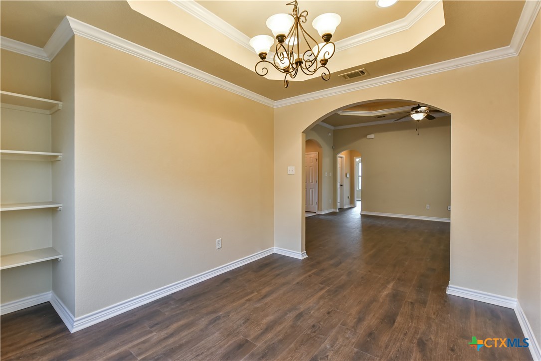 6905 Deorsam Loop Killeen, TX 76542 - Photo 7 of 21 a view of a hallway with wooden floor and a chandelier
