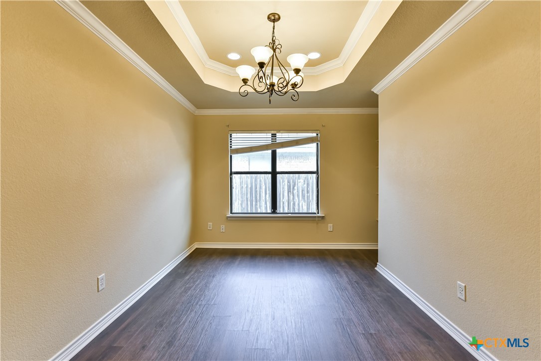 6905 Deorsam Loop Killeen, TX 76542 - Photo 8 of 21 wooden floor in an empty room with a window