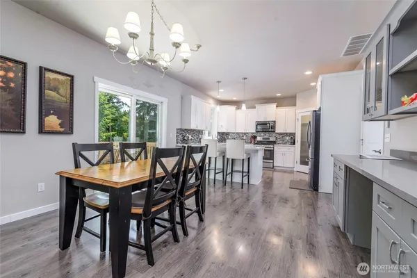 a kitchen with kitchen island a counter top space appliances and cabinets