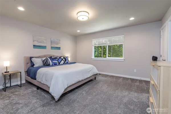 a bed sitting in a bedroom next to a window
