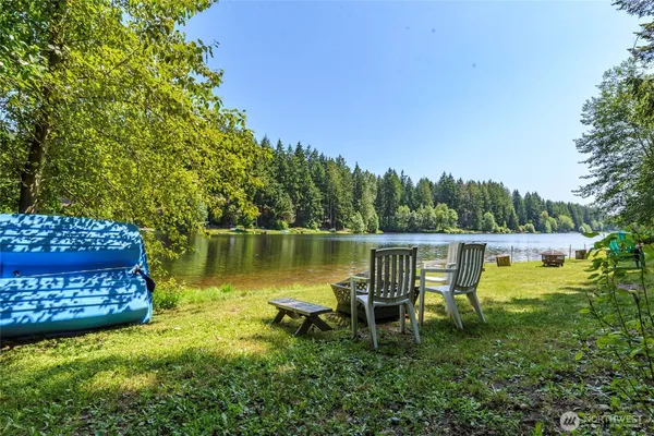 a view of a lake with a bench in a garden