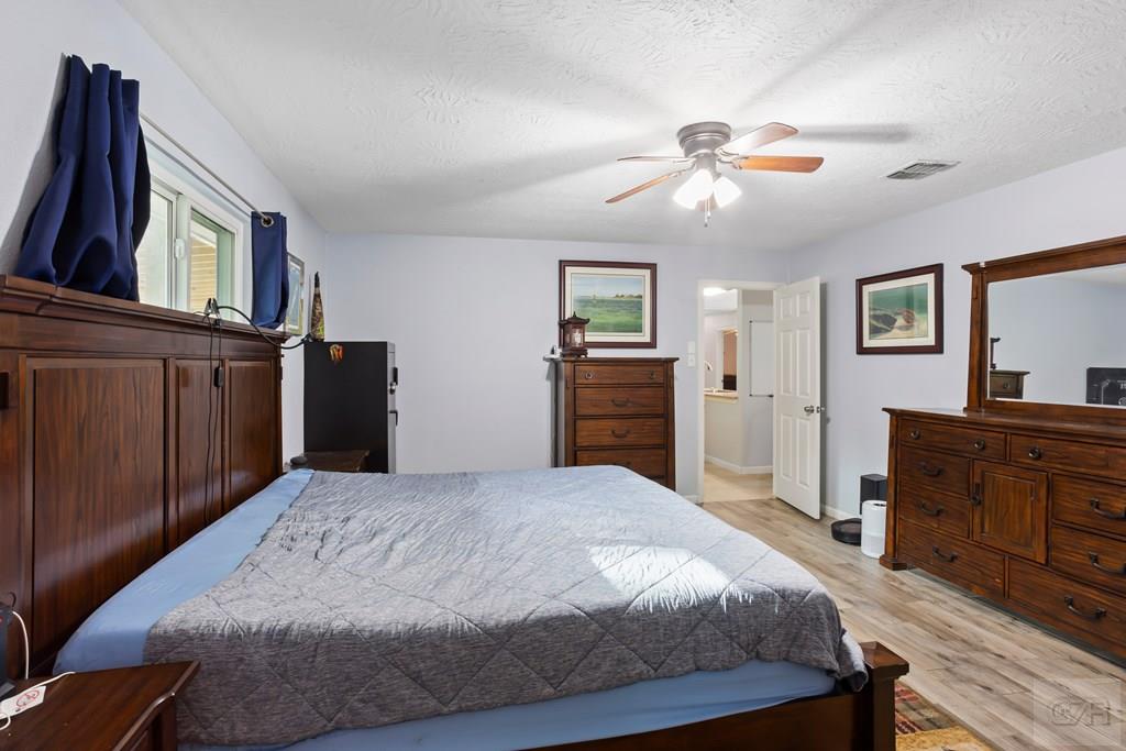 5607 Commodore Drive Dickinson, TX 77539 - Photo 11 of 23 a bedroom with a bed and a dresser