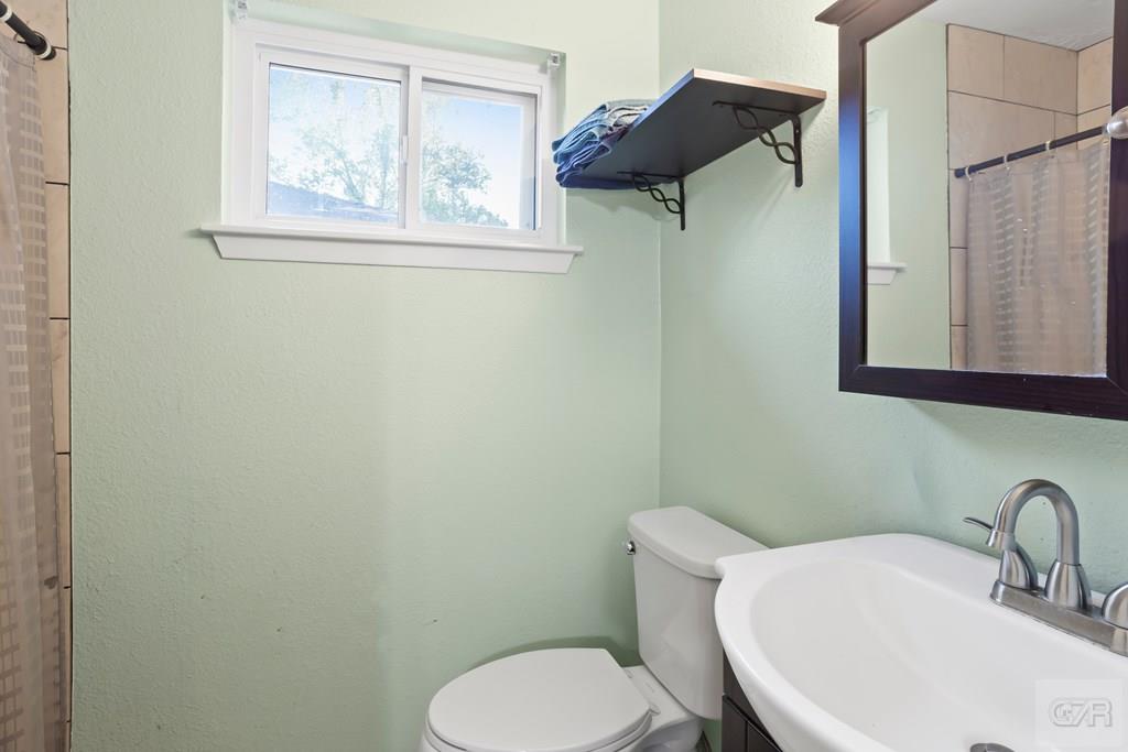 5607 Commodore Drive Dickinson, TX 77539 - Photo 12 of 23 a bathroom with a toilet and a sink