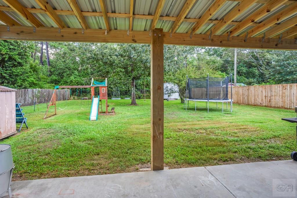 5607 Commodore Drive Dickinson, TX 77539 - Photo 17 of 23 a view of a backyard with a slide