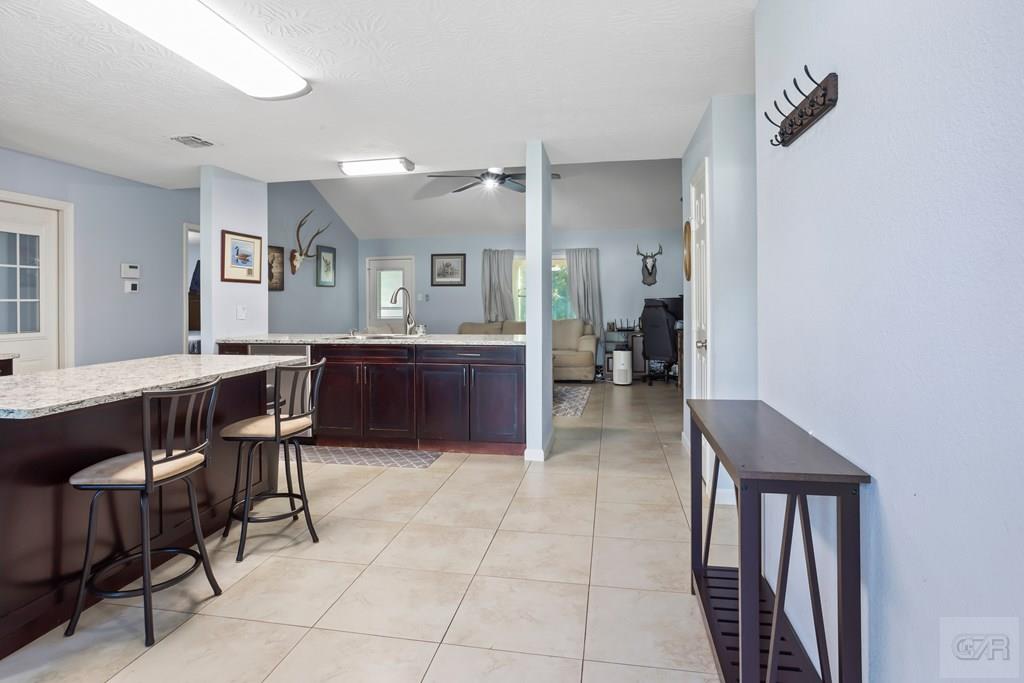 5607 Commodore Drive Dickinson, TX 77539 - Photo 4 of 23 a kitchen with granite countertop a table and chairs in it
