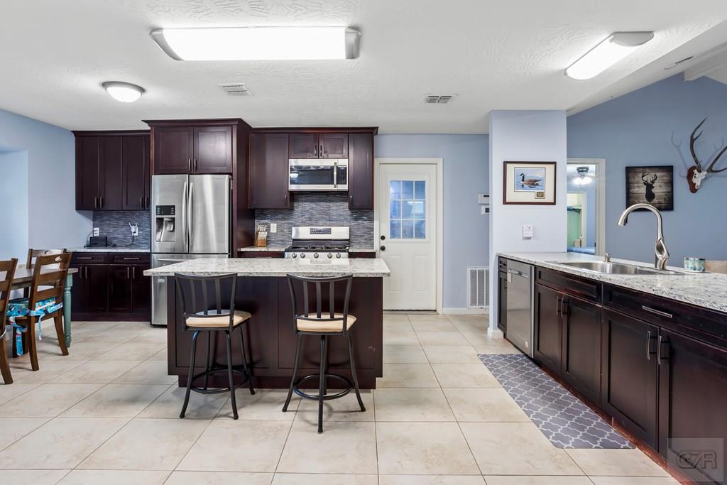 5607 Commodore Drive Dickinson, TX 77539 - Photo 7 of 23 a large kitchen with a table and chairs in it
