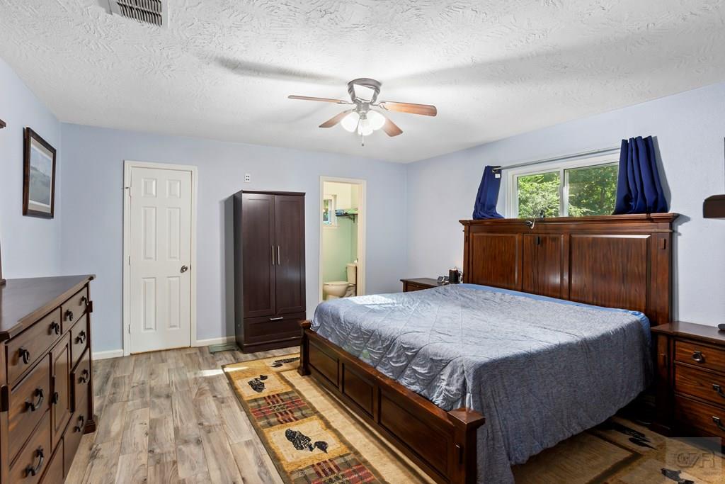 5607 Commodore Drive Dickinson, TX 77539 - Photo 10 of 23 a bedroom with a bed and a dresser