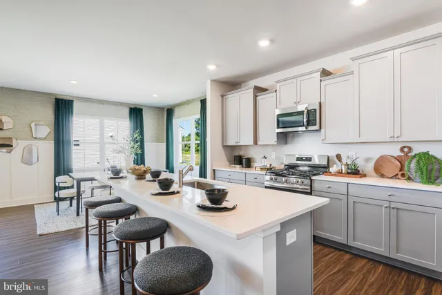 a kitchen with sink a stove and cabinets