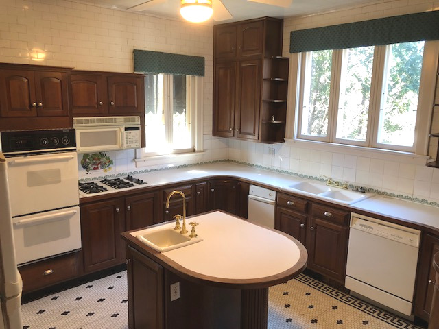 906 North Sheridan Road Waukegan, IL 60085 - Photo 11 of 34 a kitchen with a sink a stove and refrigerator
