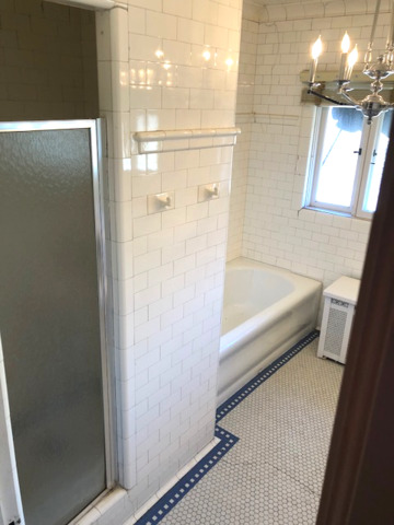 906 North Sheridan Road Waukegan, IL 60085 - Photo 21 of 34 a bathroom with a bathtub and a shower