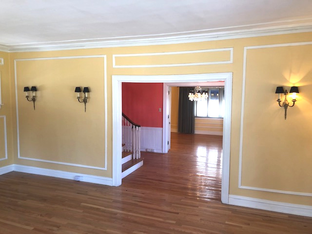 906 North Sheridan Road Waukegan, IL 60085 - Photo 7 of 34 a view of a hallway with wooden floor and a living room