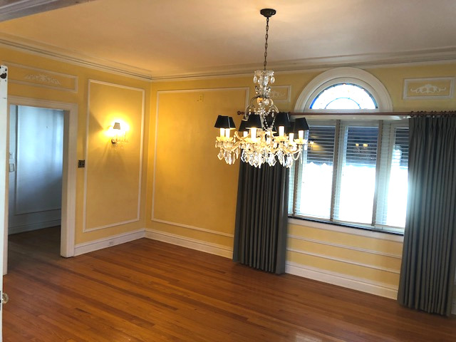 906 North Sheridan Road Waukegan, IL 60085 - Photo 8 of 34 a view of a hallway with wooden floor and chandelier