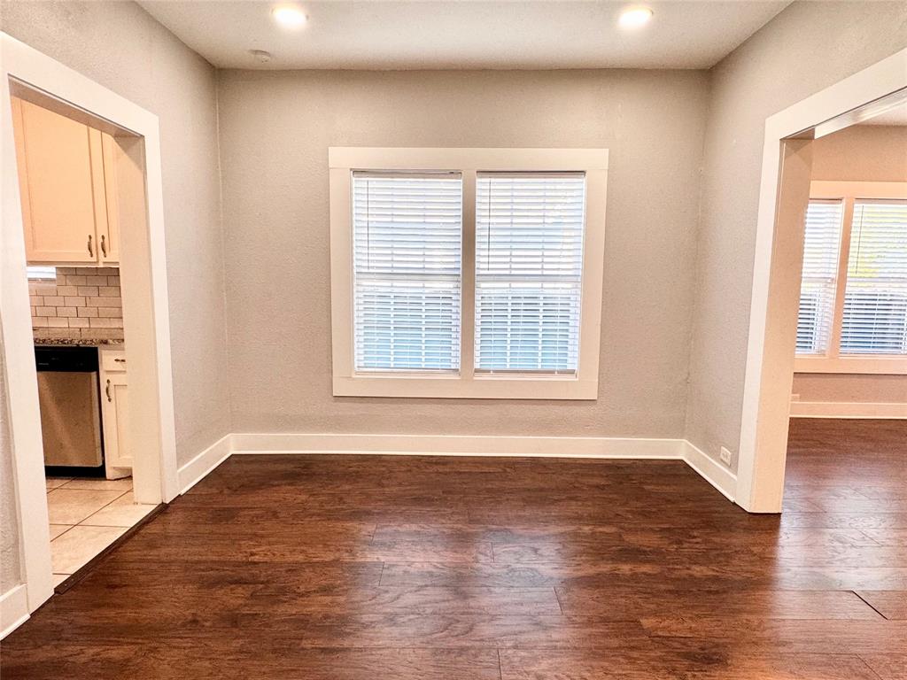 3455 Roberts Avenue Dallas, TX 75215 - Photo 11 of 25 an empty room with wooden floor and windows